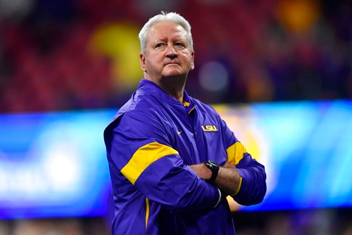 LSU Offensive Coordinator Steve Ensminger watches teams warm up before the first half of the Peach Bowl NCAA semifinal college football playoff game between LSU and Oklahoma, Saturday, Dec. 28, in Atlanta. Ensminger's daughter-in-law, Carley McCord, died in a plane crash Saturday in Louisiana on the way to the game. (AP Photo/John Amis)