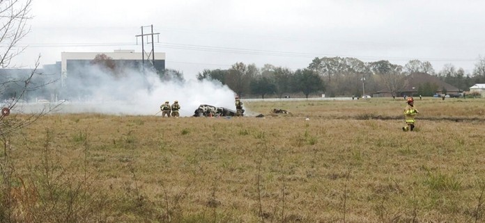 This photo provided by Acadian News shows first responders looking over the site of the plane crash. (Acadian News via AP)