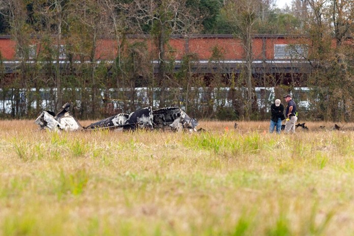 Fire and Police respond to the scene after a small plane crashed into the parking lot of a post office in Lafayette, La., Saturday, Dec. 28, 2019. Several people died in the crash. (Scott Clause/The Lafayette Advertiser via AP)