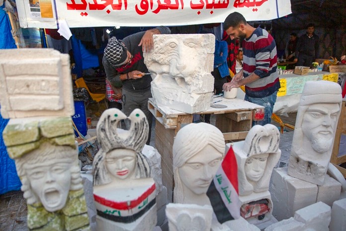 Young Iraqi trainees work on sculptures in preparation for their upcoming art exhibition during the ongoing protests in Tahrir square, Baghdad, IraqDec. 17, 2019. (AP Photo/Nasser Nasser)