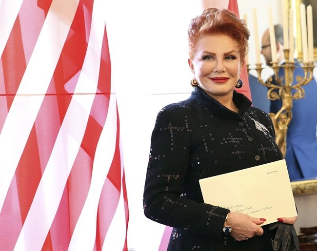 Georgette Mosbacher stands next to an American flag after receiving her credentials as new United States ambassador to Poland in WarsawSept. 6, 2018. (AP Photo/Czarek Sokolowski, File)