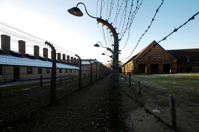 The sun lights the buildings behind near the entrance of the former Nazi death camp of Auschwitz-Birkenau in Oswiecim, Germany, Friday, Dec. 6, 2019. (Photo/Markus Schreiber)