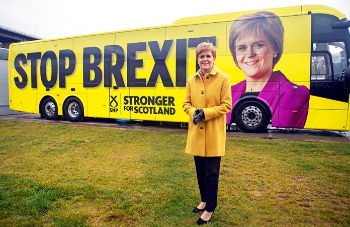 Scottish National Party (SNP) leader Nicola Sturgeon launches the party's election campaign bus, featuring a portrait of herself, at Port Edgar Marina in the town of South Queensferry, Scotland, before setting off on a tour of Scotland for the final week of the SNP's General Election campaign, Thursday Dec. 5, 2019. (Jane Barlow/PA via AP)