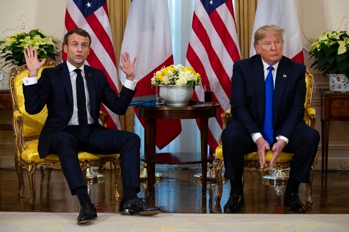 President Donald Trump listens as French President Emmanuel Macron speaks during a meeting at Winfield House during the NATO summit, Tuesday, Dec. 3, 2019, in London. (AP Photo/ Evan Vucci)