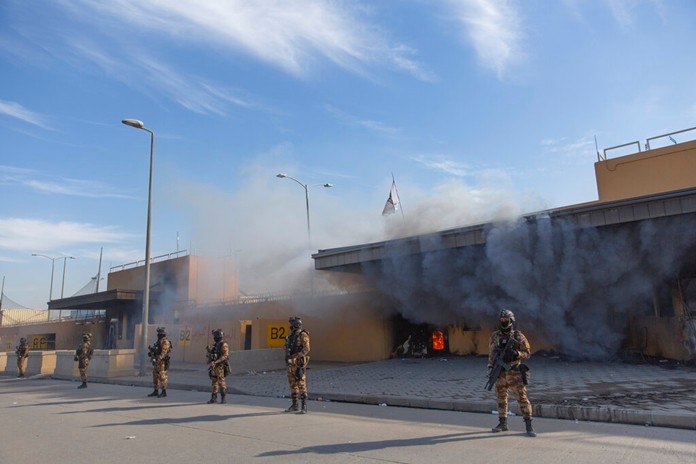 Iraqi army soldiers are deployed in front of the U.S. embassy, in Baghdad, Iraq, Wednesday, Jan. 1, 2020. Iran-backed militiamen have withdrawn from the U.S. Embassy compound in Baghdad after two days of clashes with American security forces. (AP Photo/Nasser Nasser)