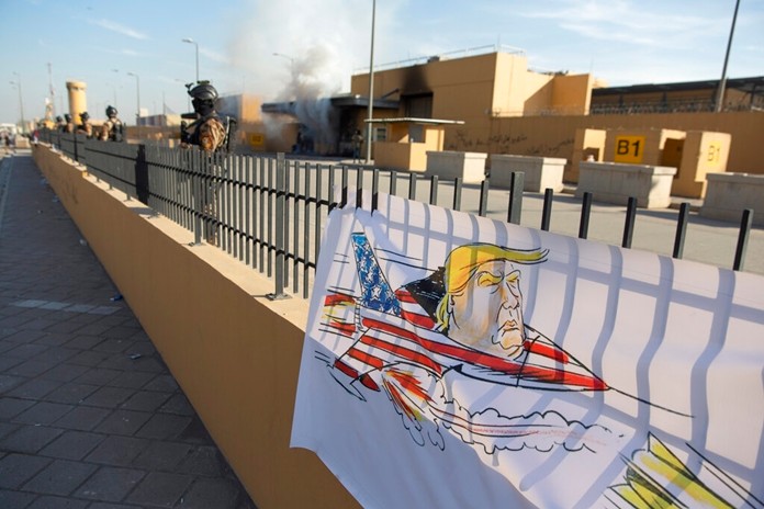 Iraqi army soldiers are deployed in front of the U.S. embassy, in Baghdad, Iraq, Wednesday, Jan. 1, 2020. (AP Photo/Nasser Nasser)