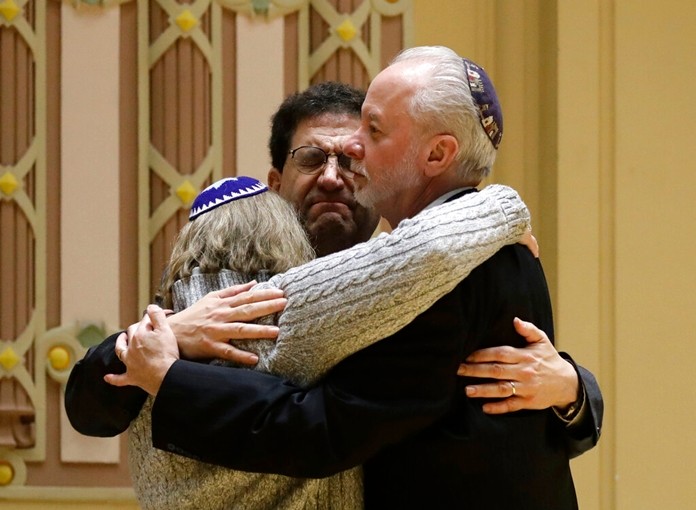 In this Oct. 28, 2018, file photo, Rabbi Jeffrey Myers, right, of Tree of Life/Or L'Simcha Congregation hugs Rabbi Cheryl Klein, left, of Dor Hadash Congregation and Rabbi Jonathan Perlman during a community gathering held in the aftermath of a deadly shooting at the Tree of Life Synagogue in Pittsburgh. (AP Photo/Matt Rourke, File)