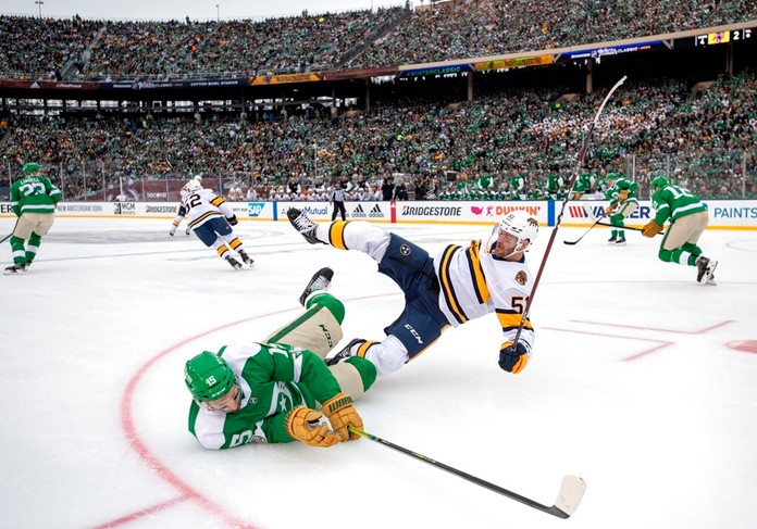 Dallas Stars left wing Blake Comeau (15) falls to the ice after being checked by Nashville Predators left wing Austin Watson (51) in the first period of the NHL Winter Classic hockey game at the Cotton Bowl, Wednesday, Jan. 1, 2020, in Dallas. (AP Photo/Jeffrey McWhorter)