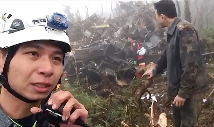 In this image made from video, emergency teams work at the crash site of a military helicopter in the mountains of Yilan, north eastern Taiwan, Thursday, Jan. 2, 2020. (Yilan Fire Bureau via AP)
