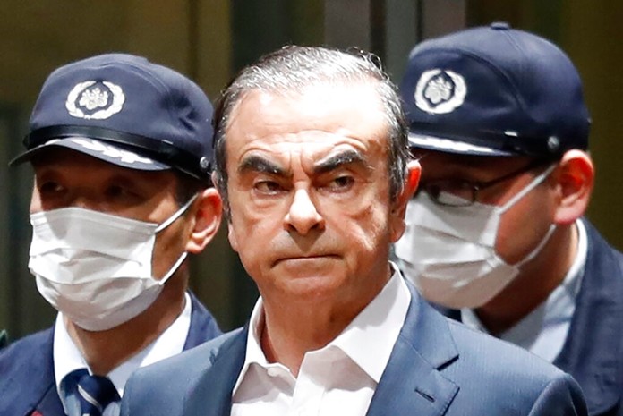 In this April 25, 2019, file photo, former Nissan Chairman Carlos Ghosn leaves Tokyo's Detention Center for bail in Tokyo. By jumping bail, Ghosn, who had long insisted on his innocence, has now committed a clear crime and can never return to Japan without going to jail. (Kyodo News via AP, File)