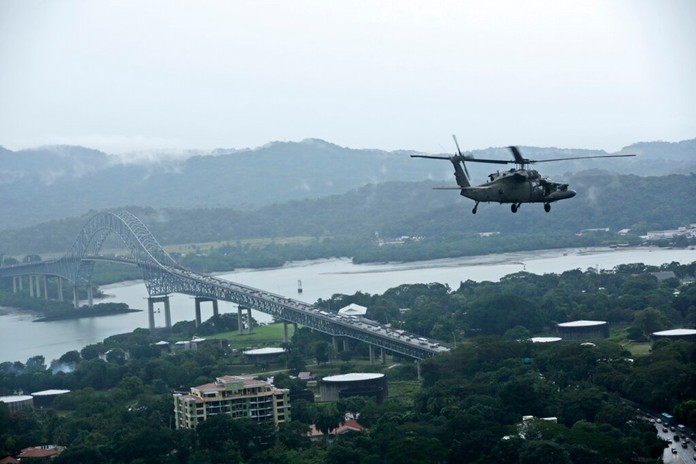 In this Dec. 6, 2019 file photo, a U.S. military Black Hawk helicopter flies over the Pacific side of the Panama Canal as it travels to the Darien province to provide a humanitarian assistance in Panama. (AP Photo/Arnulfo Franco, File)