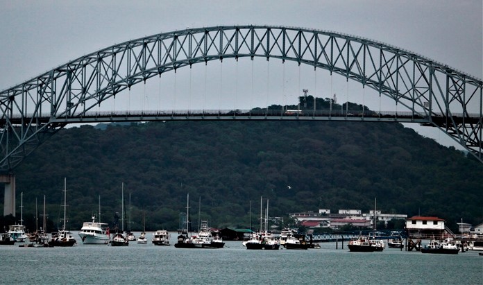 Small boats sit parked in a marina near the Bridge of the Americas, at the entrance to the Panama Canal in Panama City, Tuesday, Dec. 31, 2019, on the 20th anniversary of the canal's turnover from the U.S. (AP Photo/Eric Batista)