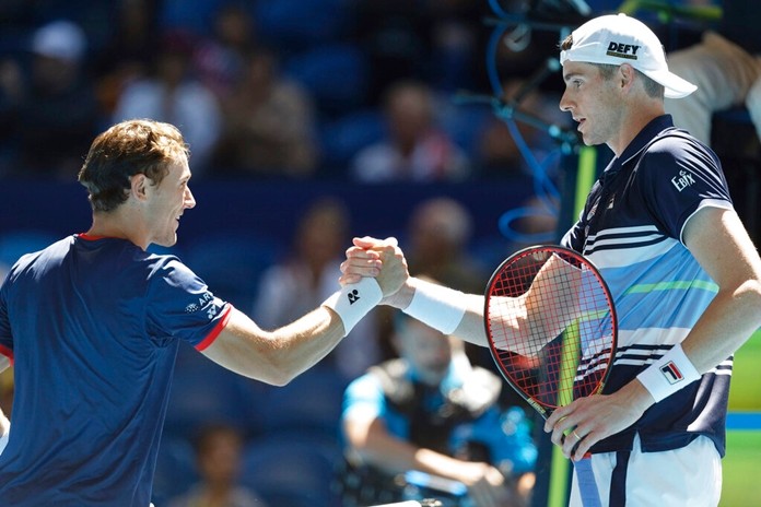 Casper Ruud, left, of Norway shakes hands at the net after his win over John Isner of the United States during their match at the ATP Cup in Perth, Australia, Friday, Jan. 3, 2020. (AP Photo/Trevor Collens)