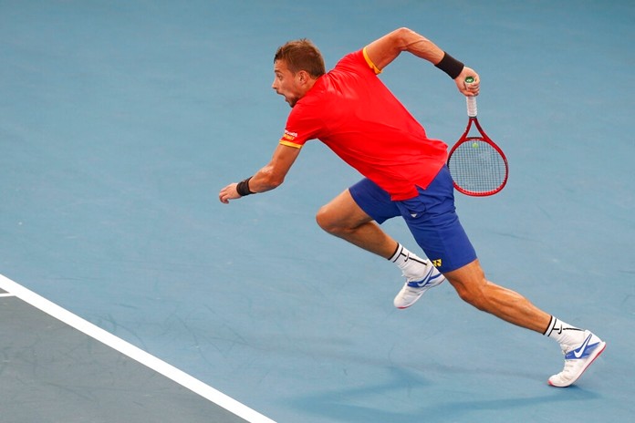 Alexander Cozbinov of Moldova sprints for the ball during a match against Steve Darcis of Belgium at their ATP Cup tennis match in Sydney, Friday, Jan. 3, 2020. (AP Photo/Steve Christo)