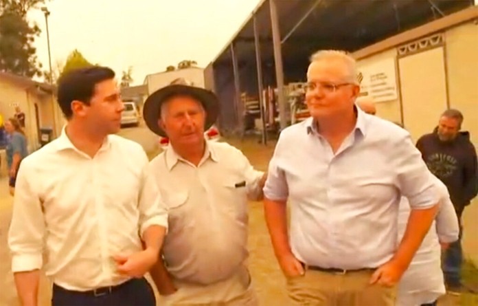 This still image taken from video provided by AuBC, Australian Prime Minister Scott Morrison is confronted by angry residents as he visited a wildfire-ravaged Cobargo, in New South Wales on Thursday, Jan. 2, 2020. (AuBC via AP)