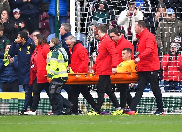Aston Villa goalkeeper Tom Heaton, centre, is carried off the pitch on a stretcher, during the English Premier League soccer match between Burnley and Aston Villa, at Turf Moor, Burnley, England, Wednesday Jan. 1, 2020. (Anthony Devlin/PA via AP)