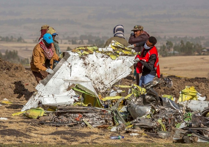 In this file photo dated Monday, March 11, 2019, rescuers work at the scene of an Ethiopian Airlines plane crash south of Addis Ababa, Ethiopia. (AP Photo/Mulugeta Ayene, FILE)