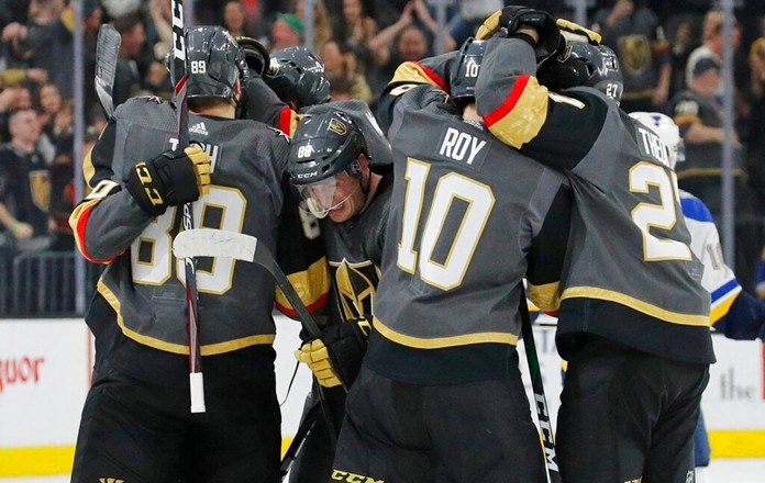 Vegas Golden Knights celebrate after defeating the St. Louis Blues during overtime of an NHL hockey game Saturday, Jan. 4, 2020, in Las Vegas. (AP Photo/John Locher)