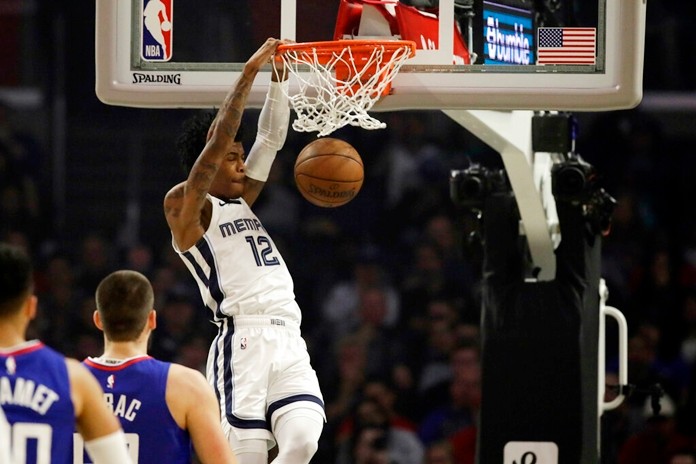 Memphis Grizzlies' Ja Morant (12) dunks against the Los Angeles Clippers during the first half of an NBA basketball game Saturday, Jan. 4, 2020, in Los Angeles. (AP Photo/Marcio Jose Sanchez)