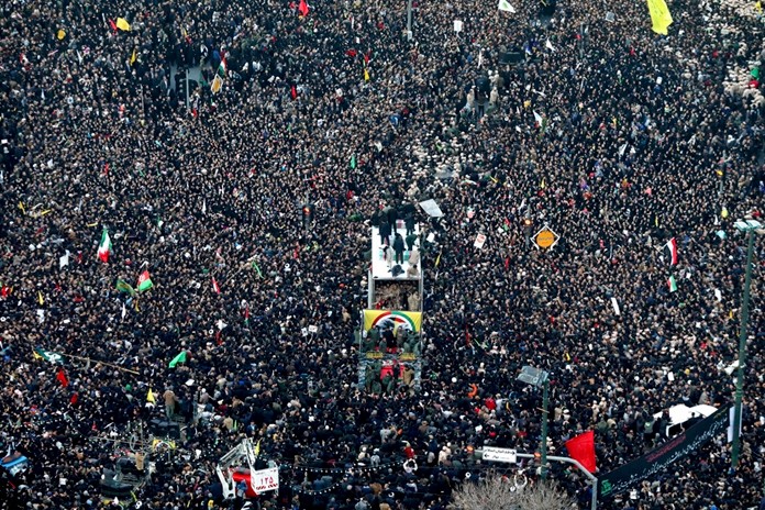Coffins of Gen. Qassem Soleimani and others who were killed in Iraq by a U.S. drone strike, are carried on a truck surrounded by mourners during a funeral procession, in the city of Mashhad, Iran, Sunday, Jan. 5, 2020. (Mohammad Hossein Thaghi/Tasnim News Agency via AP)