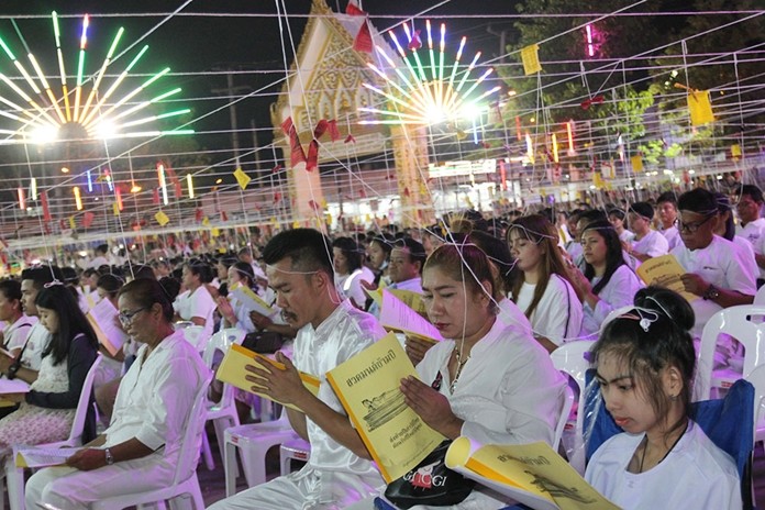 On New Year's Eve at Sutthawat Temple in Nongprue, monks and followers pray and monks chant “The Verses of the Buddha's Auspicious Victories” at midnight.