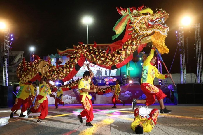 Skilled actors perform a magical dragon and lion dance at Lan Pho Public Park in Naklua.