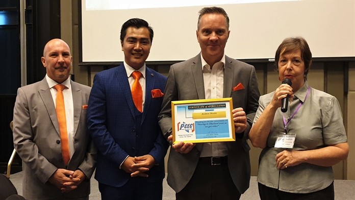 MC Judith Edmonds presents the PCEC's Certificate of Appreciation to Andrew Stocks, joined by his fellow Sunshine Representatives Ittphuman Tanatchok and Torsten Voigt, for his interesting presentation about Sunshine Residences advantages for older Expats.