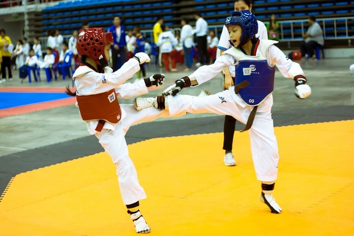 Young martial artists high-kick their way through the qualifying round.