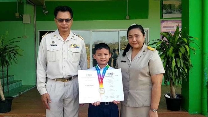 First grader Than Thongnoon shows off his gold medal won at the 2019 World International Mathematical Olympiad. First grader Chatdanai Limsirilangsan (not shown) also won gold.