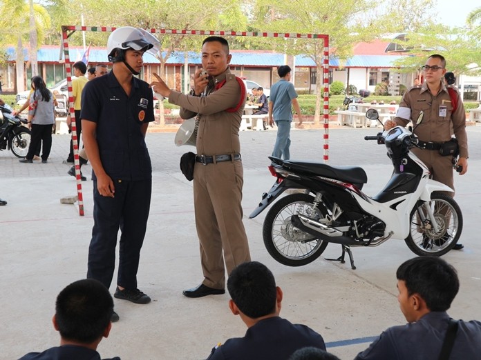 Banglamung police look for modified motorbikes at Pattaya Technical College.