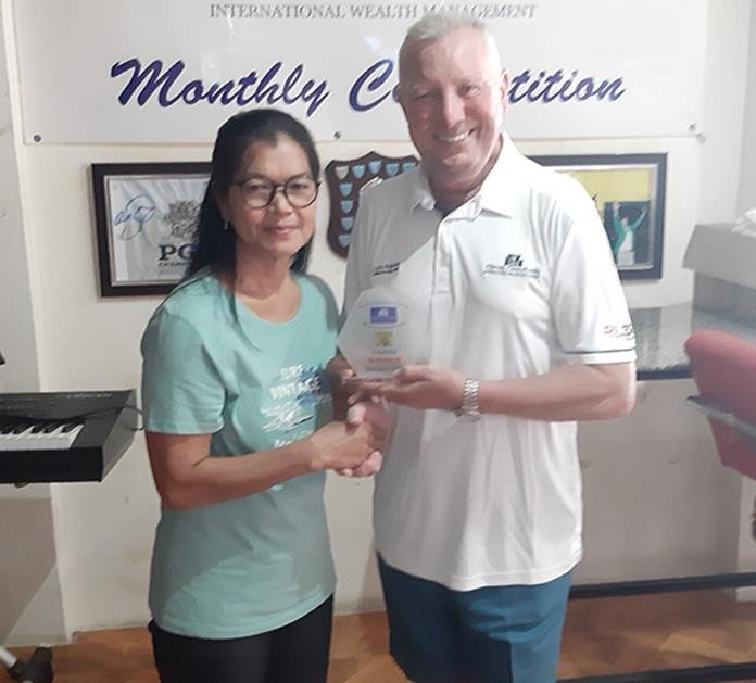 Brian Chapman presents the trophy to Miss Nu who carded a 77 gross off her 15 handicap to take the Haven Trophy with a net 62.