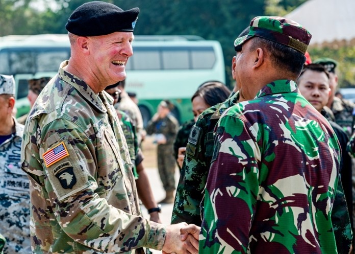 U.S. Army Maj. Gen. Pete Johnson, U.S. Army Pacific deputy commander representing U.S. Indo-Pacific Command, shakes hands with an Indonesian soldier during the opening ceremony of exercise Cobra Gold 2020, Tuesday Feb. 25, 2020. (U.S. Navy photo by Mass Communication Specialist 1st Class Julio Rivera)