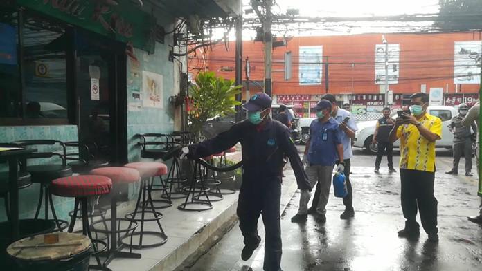 Health Department workers spray down Soi 6 bars and clean the street to make sure punters feel safe from disease.