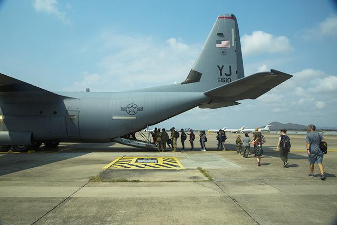 Evacuees prepare to board a U.S. Air Force C-130 Hercules aircraft as part of a simulated noncombatant evacuation operation during Exercise Cobra Gold 2020 at U-Tapao Airfield, Rayong, Feb. 29, 2020. (U.S. Marine Corps photo by Sgt. Audrey M. C. Rampton)