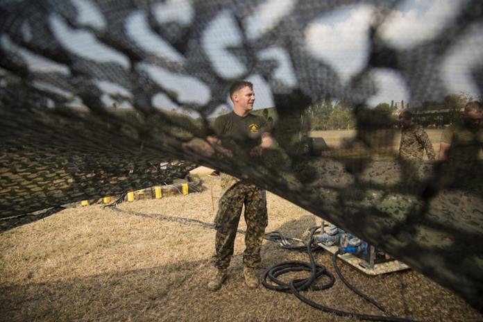 U.S. Marine Cpl. Matthew Power handles camouflage netting for a direct air support center as part of Exercise Cobra Gold 2020 at Camp Phra Maha Jetsadaratchao, Chon Buri, Kingdom of Thailand, Feb. 26, 2020. Power, a native of Beaufort, S.C., is an air support operations operator with Marine Air Support Squadron 2, 1st Marine Aircraft Wing. (U.S. Marine Corps photo by Staff Sgt. Jordan E. Gilbert)