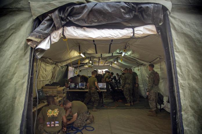 U.S. Marines with Marine Air Support Squadron 2, 1st Marine Aircraft Wing, set up wiring and computer workstations for a direct air support center as part of Exercise Cobra Gold 2020 at Camp Phra Maha Jetsadaratchao, Chon Buri, Kingdom of Thailand, Feb. 26, 2020. (U.S. Marine Corps photo by Staff Sgt. Jordan E. Gilbert) (This image has been altered for security purposes)