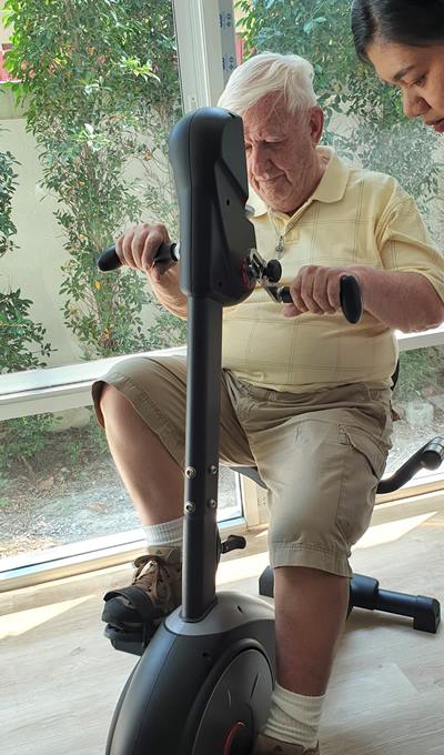PCEC member Roger Fox gives some of the Homerly Senor Living Facility's exercise equipment a tryout.
