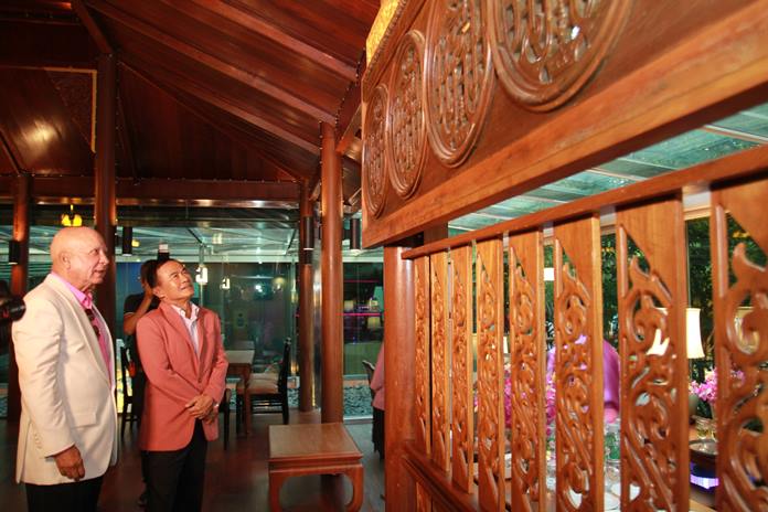 Gen. Paiboon Khumchaya admires the intricate hand-carved teak wood decor in one of the pavilions.