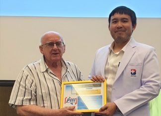 MC Les Edmonds presents Dr. Tanarat with the PCEC's Certificate of Appreciation for his informative talk about ankle and foot problems and how to avoid them.