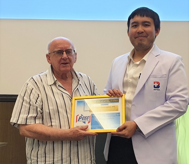 MC Les Edmonds presents Dr. Tanarat with the PCEC's Certificate of Appreciation for his informative talk about ankle and foot problems and how to avoid them.