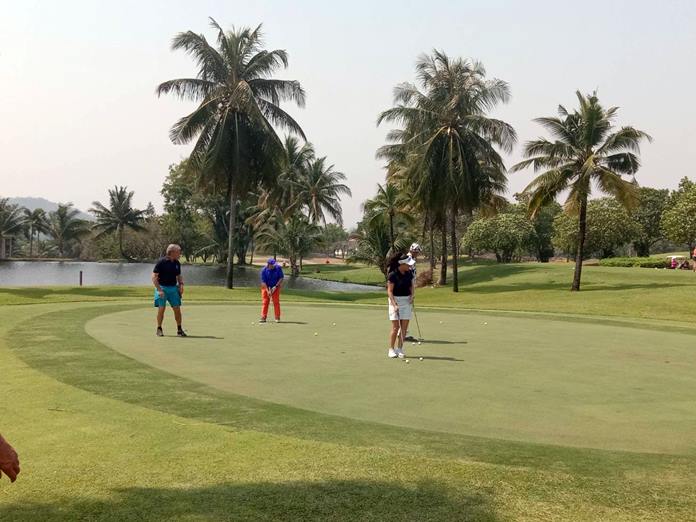 Smart golfers get ready on the putting green.