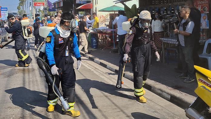Workers spray disinfectants in the streets to protect against the coronavirus in Sattahip.