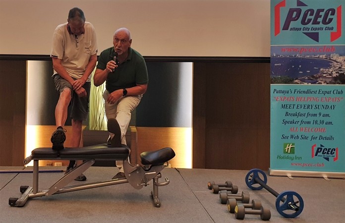 PCEC Member George Wilson assists speaker David Shnider in showing one of several proper ways to stretch, a must, before beginning to exercise.