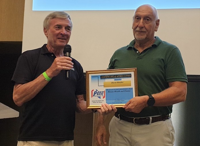 MC Ron Hunter provides David Shnider with the PCEC's Certificate of Appreciation for his very informative guidance on how older adults can keep fit through moderate exercise.