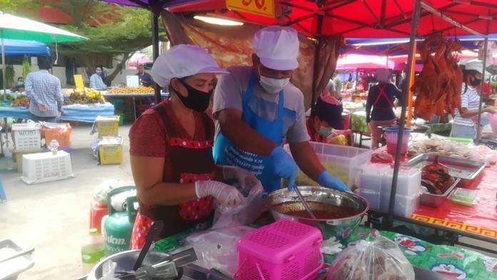 Vendors are required to wear protective gear at Wat Suttawas Flea Market.
