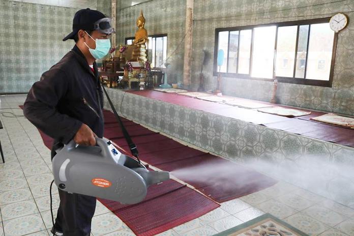 The inside of Wat Thamsamakee receives a shower of disinfectant.