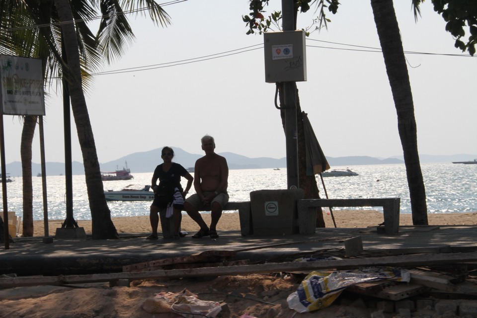 An elderly couple enjoys the serenity of Pattaya beach as the beach closing order takes effect.