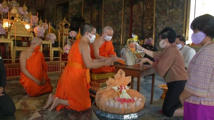Monks at temples in Bangkok are presented with face-masks to prevent themselves from catching COVID-19