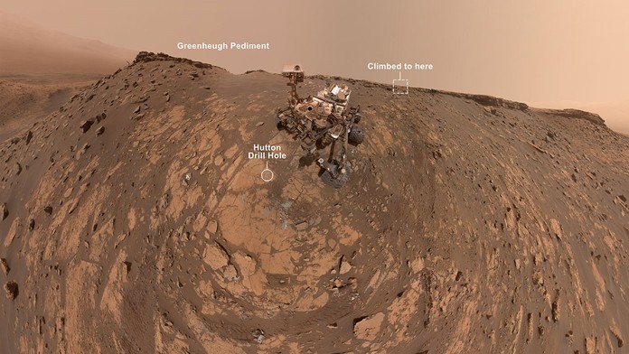 This selfie was taken by NASA's Curiosity Mars rover on Feb. 26, 2020 (the 2,687th Martian day, or sol, of the mission). The crumbling rock layer at the top of the image is "the Greenheugh Pediment," which Curiosity climbed soon after taking the image. 