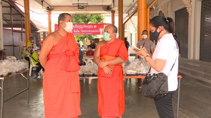 Bangkok’s Wat Arun temple on the bank of the Chao Phraya River offers food to those affected by businesses closures and the virus control measures.